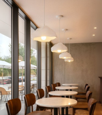 Drift White Foam Pendant with cloud-like sculptural shape above dining and café interiors.