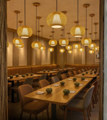 Handwoven wicker pendant lighting above cafe seating with wooden tables and chairs