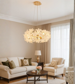 Floral glass chandelier with gold finish in a modern living room.