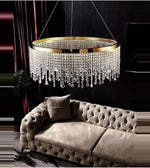 Luxury crystal chandelier above tufted beige velvet sofa in elegant modern living room