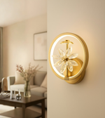 Modern circular LED wall light with amber crystal flower accents mounted on a wooden interior wall