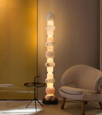 Sculptural marble floor lamp emitting warm ambient light in modern living room