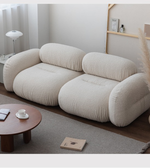 Lumo Curve modular sofa by Daya Worldwide featuring sleek, curved design and plush cushions in a modern living room setting.