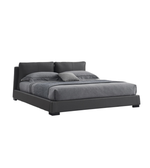 Noir Luxe upholstered bed with a padded headboard in a modern bedroom setting, featuring plush fabric and sleek design details.