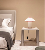 Daya Worldwide Linea Wrap Side Table, a modern bedside table with a sleek design and smooth finish, shown in a bedroom setting.