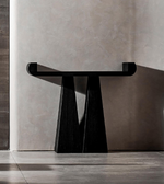 Sculpted black Daya Worldwide console table with a sleek, modern design, featuring a smooth surface and elegant curved legs.
