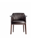 Soren leather dining chair with sleek design and cushioned seat, featuring sturdy wooden legs and modern aesthetic.