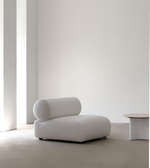 Daya Worldwide Nova lounge chair with a sleek modern design, featuring plush cushions and wooden legs in a contemporary living space.