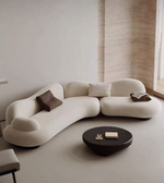 Serpentine sofa by Daya Worldwide featuring a sleek, curved design with plush upholstery and modern style in a stylish living room setting.