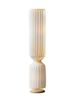 Isolated view of twisted ribbed floor lamp on white background