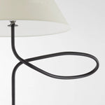 Close-up of sculptural loop arm detail on modern floor lamp