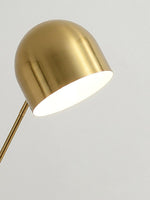 Close-up of brushed brass dome shade on modern floor lamp