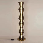 Luxury statement floor lamp placed in minimalist interior setting