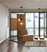 Designer wall light with two frosted glass globes in contemporary living space