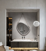 Modern bathroom interior with a round mirror and hanging light fixture.