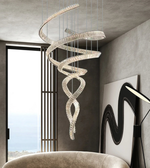 Spiral chandelier hanging in a modern interior setting with a chair and wall art.