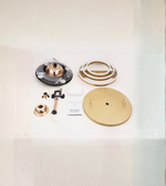 Collection of gold and black decorative items on a white surface