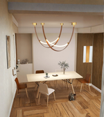Modern dining room with a chandelier, table, and chairs.