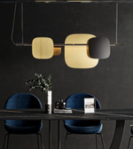 Modern dining setup with a dark wall, black table, blue chairs, and decorative elements.