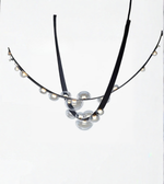 Necklace with black cord and clear beads on a white background