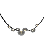 Necklace with round metallic pendants on a white background