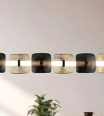 Modern wall-mounted light fixture with a plant in the foreground