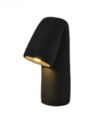 Black outdoor lamp with textured base on a white background