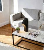Modern living room with a gray sofa, marble coffee table, and black lamp.