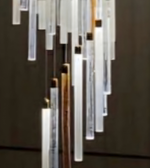 Modern chandelier with rectangular glass panels on a dark background