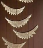 Decorative mirror with lace-like edges on a wooden background