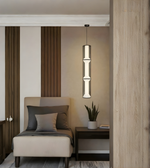 Modern interior with a pendant light, chair, and small table.