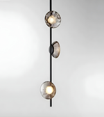 Modern pendant light with three glass shades on a white background