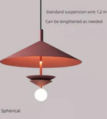 Red pendant light with a standard suspension wire on a gray background