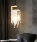 Modern pendant light with glass shade in a room setting