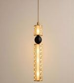 Modern pendant light with gold and black design on a beige background