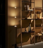 Modern shelving unit with decorative items against a patterned wall.