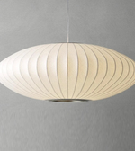 Pendant light with ribbed design on a gray background