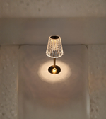 Vintage-style crystal touch table lamp glowing on tabletop