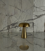 Modern gold table lamp on marble surface