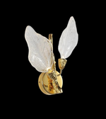 Close-up of decorative golden leaf wall light with translucent glass shades