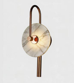 Decorative wall light fixture with marble-like design on a white background