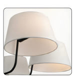 Modern wall-mounted light fixture with white lampshades on a white background