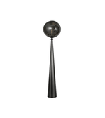 Decorative black spherical object on a long thin stand against a white background