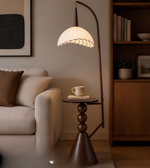 Modern living room with a floor lamp, sofa, and bookshelf.