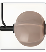 Round beige object with a black rod on a white background