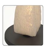 Decorative lamp with textured white shade on a black base