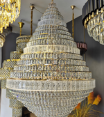 Large crystal chandelier with multiple tiers in a room setting