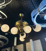 Chandelier with multiple light bulbs on a dark ceiling