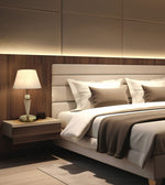 A modern bedroom interior featuring a bed with white linens and taupe pillows, a matching upholstered headboard, a floating wood nightstand with a white table lamp, and warm ambient lighting against a wood-paneled wall.