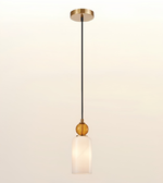 A modern single-light pendant lamp with a black cord, gold-toned metal canopy and decorative accents, and a frosted white glass shade, shown against a plain light background.
